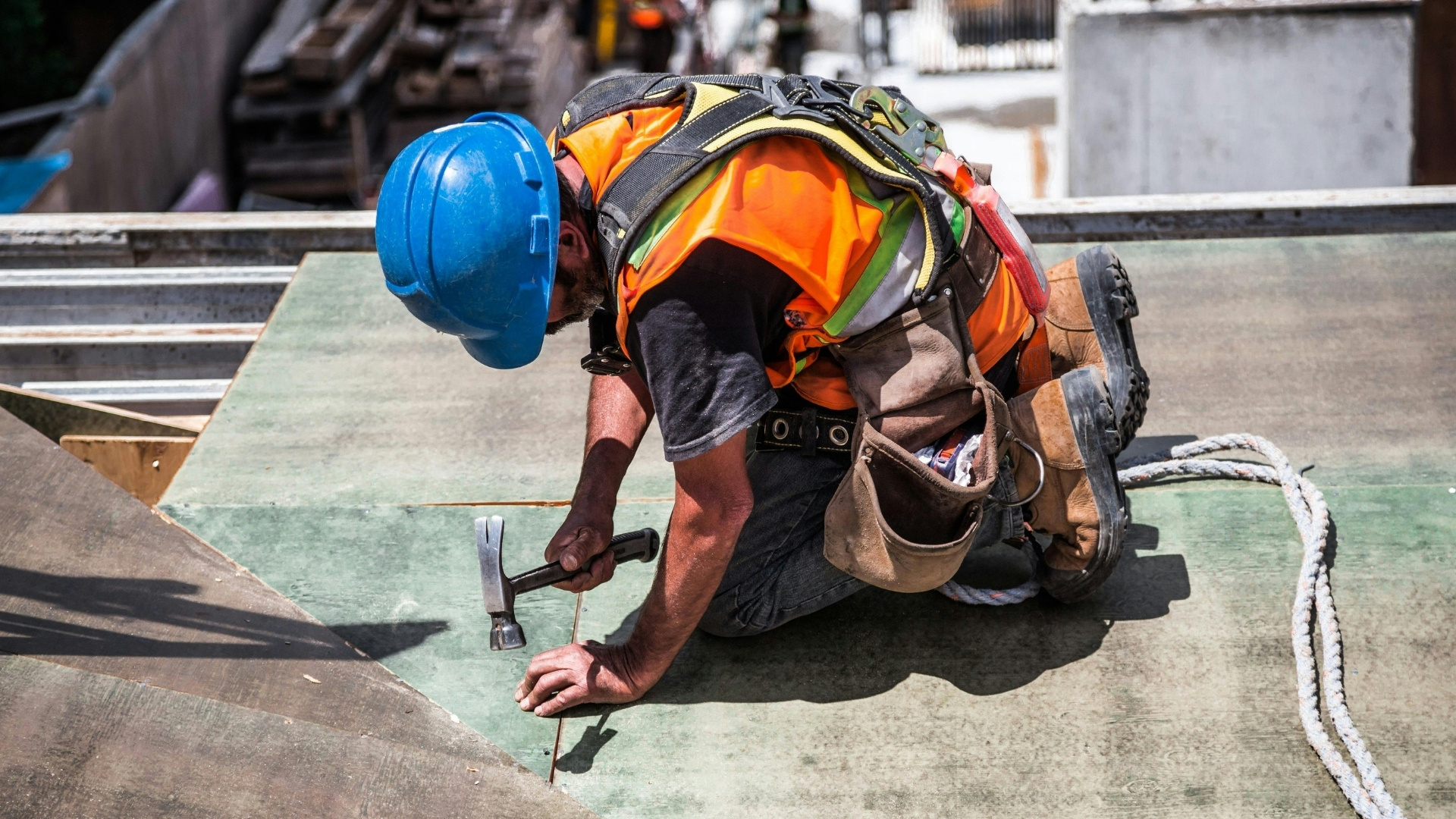 Construction worker nailing roof
