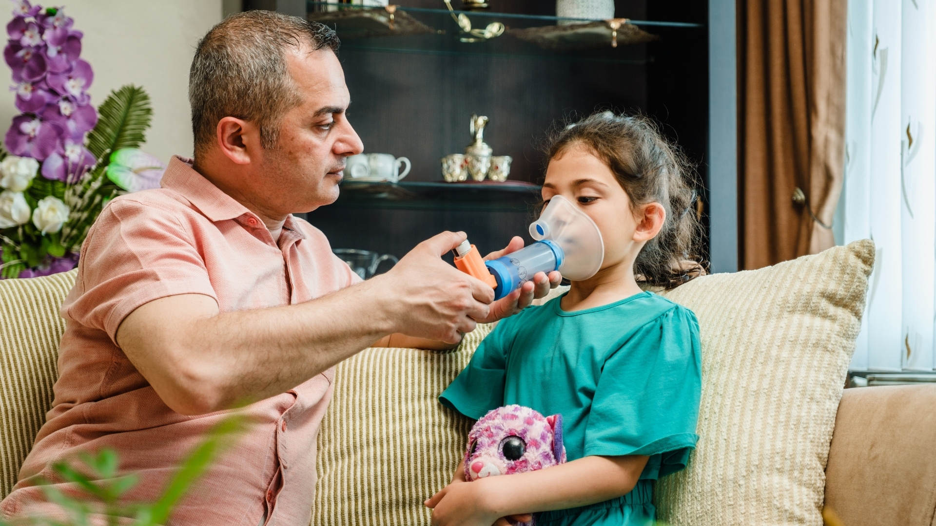 Dad helping daughter with inhaler