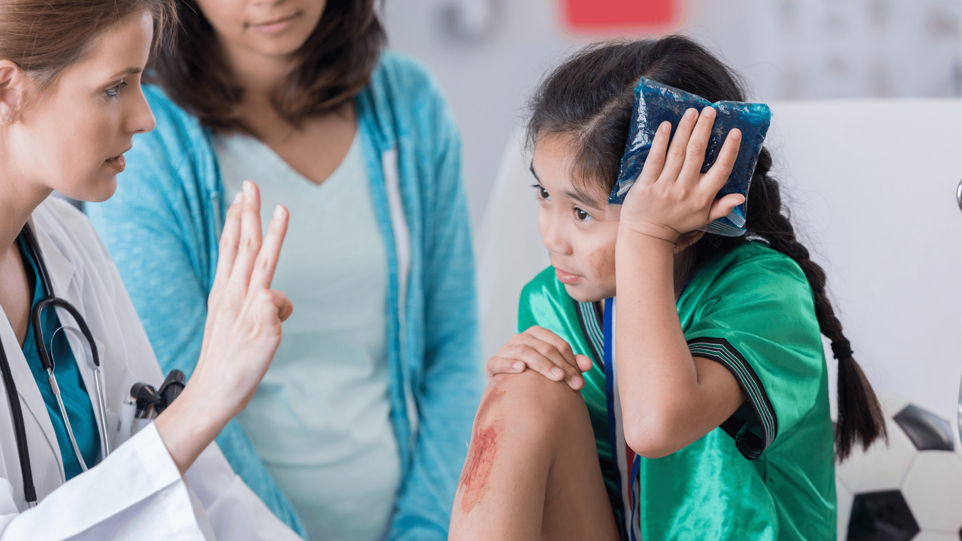 Doctor holding finger up, bruised child holidng ice pack to head