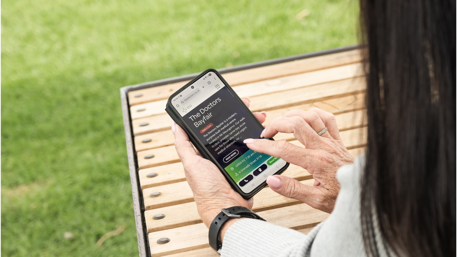 Hand on smartphone with TD website