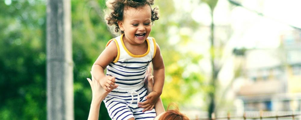 Happy child playing with mom