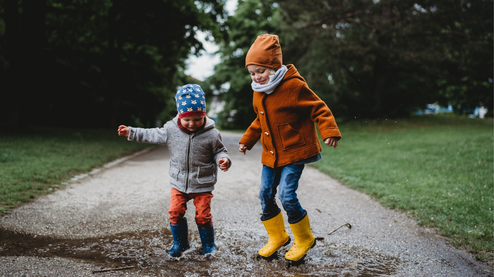 Happy children playing in puddle in winter