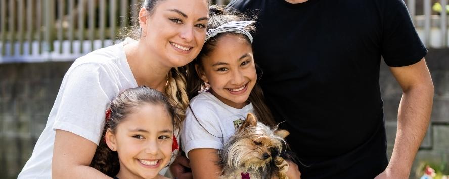 Happy whaanau with puppy