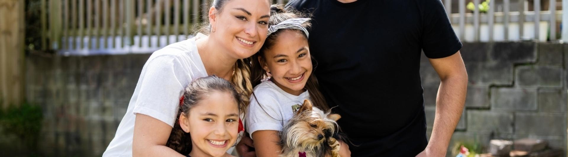 Happy whaanau with puppy