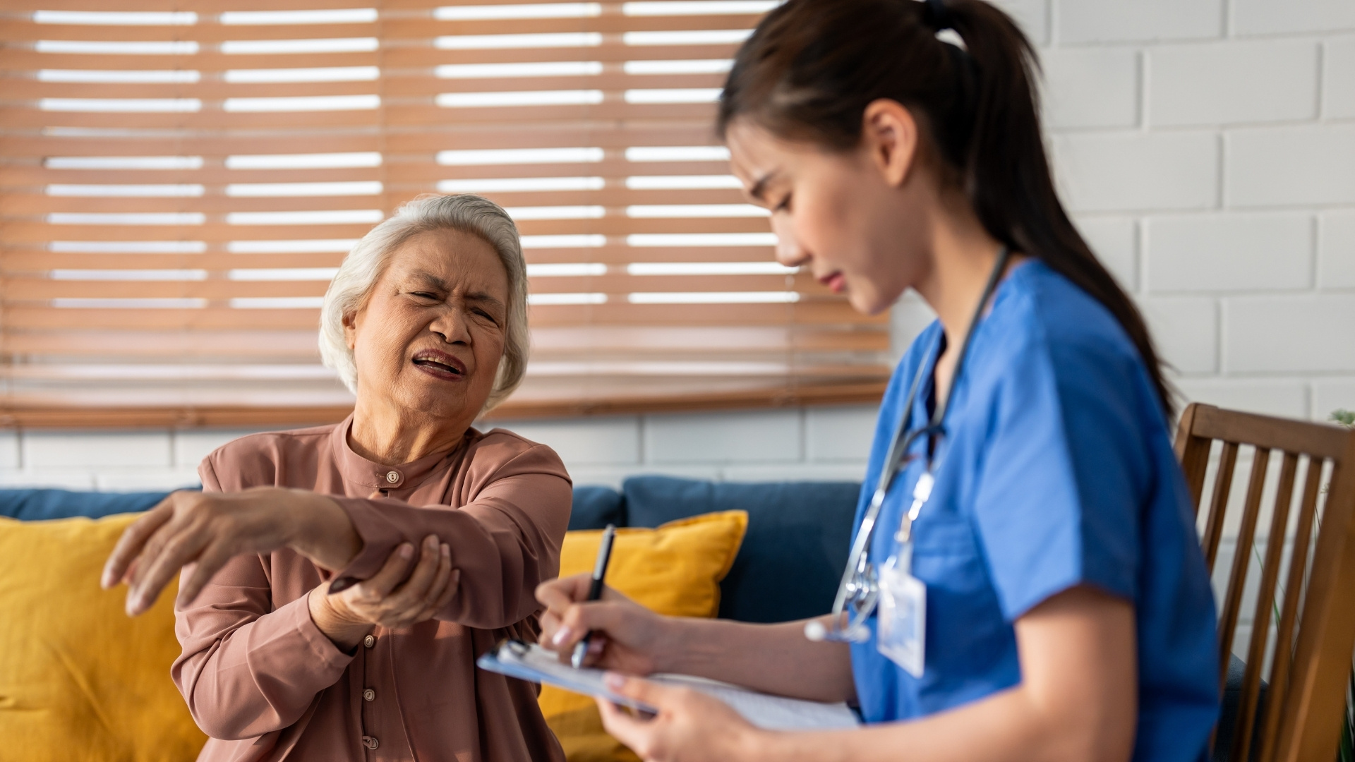 Image of female nurse helping eldery woman patient