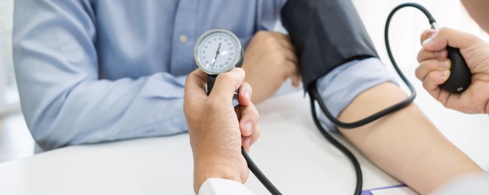 Male patient getting blood pressure taken