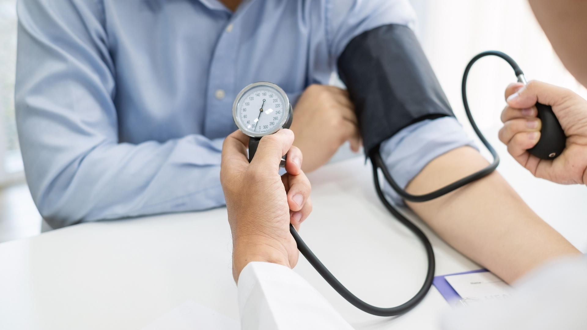 Male patient getting blood pressure taken