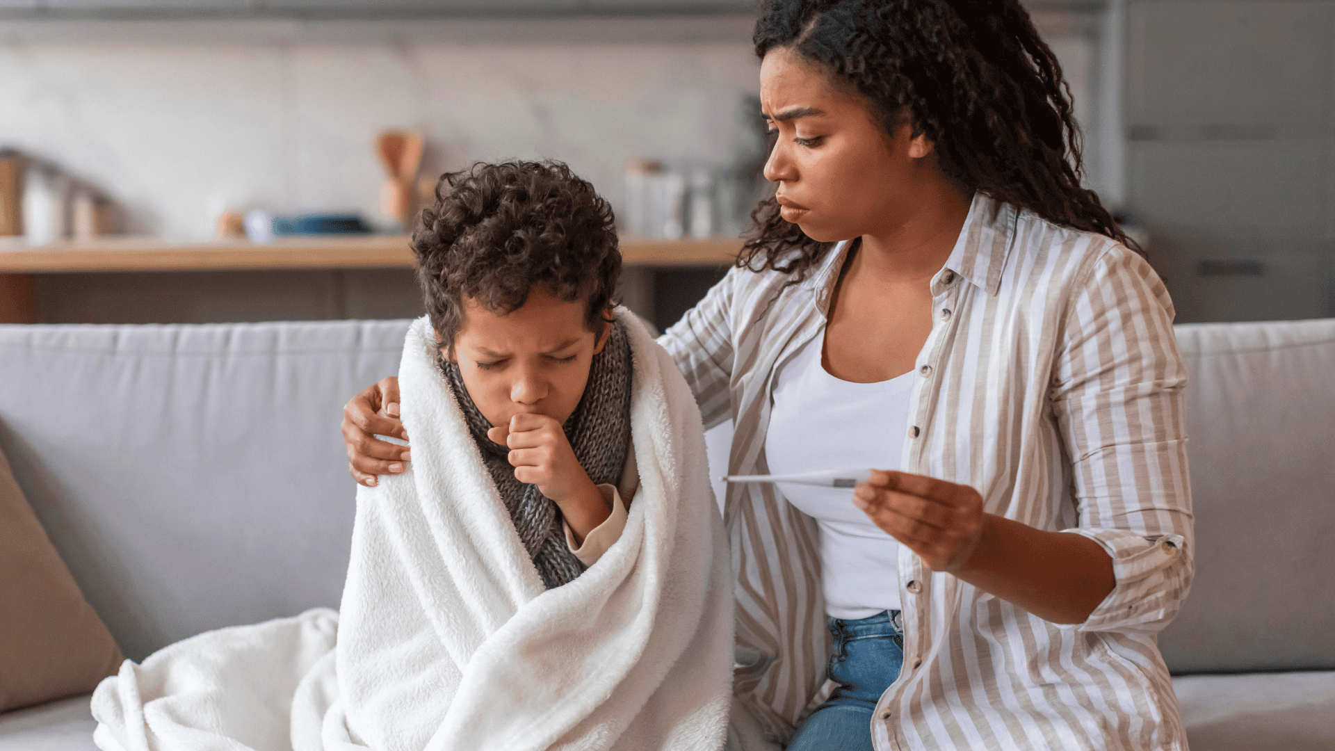 Mother helping sick couging child