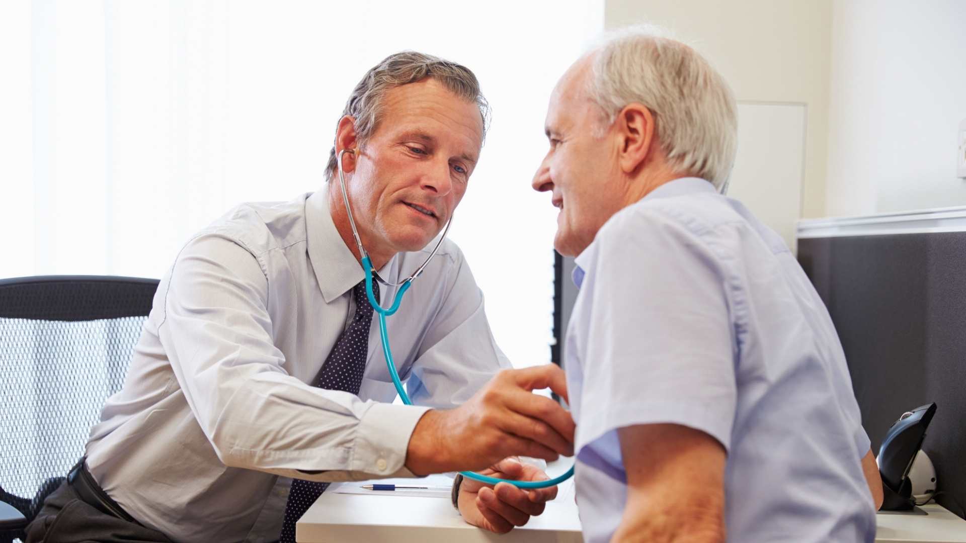 Older male doctor and older male patient