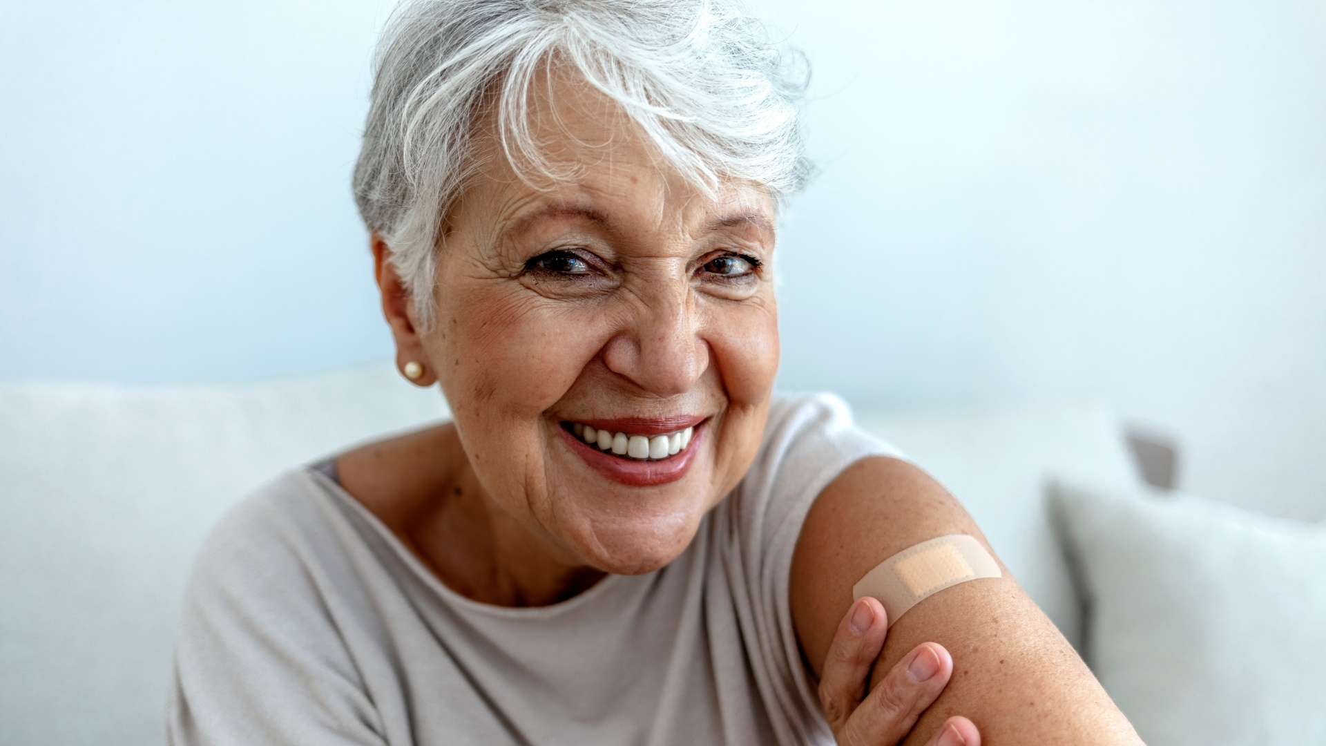 Older woman with post vaccine plaster