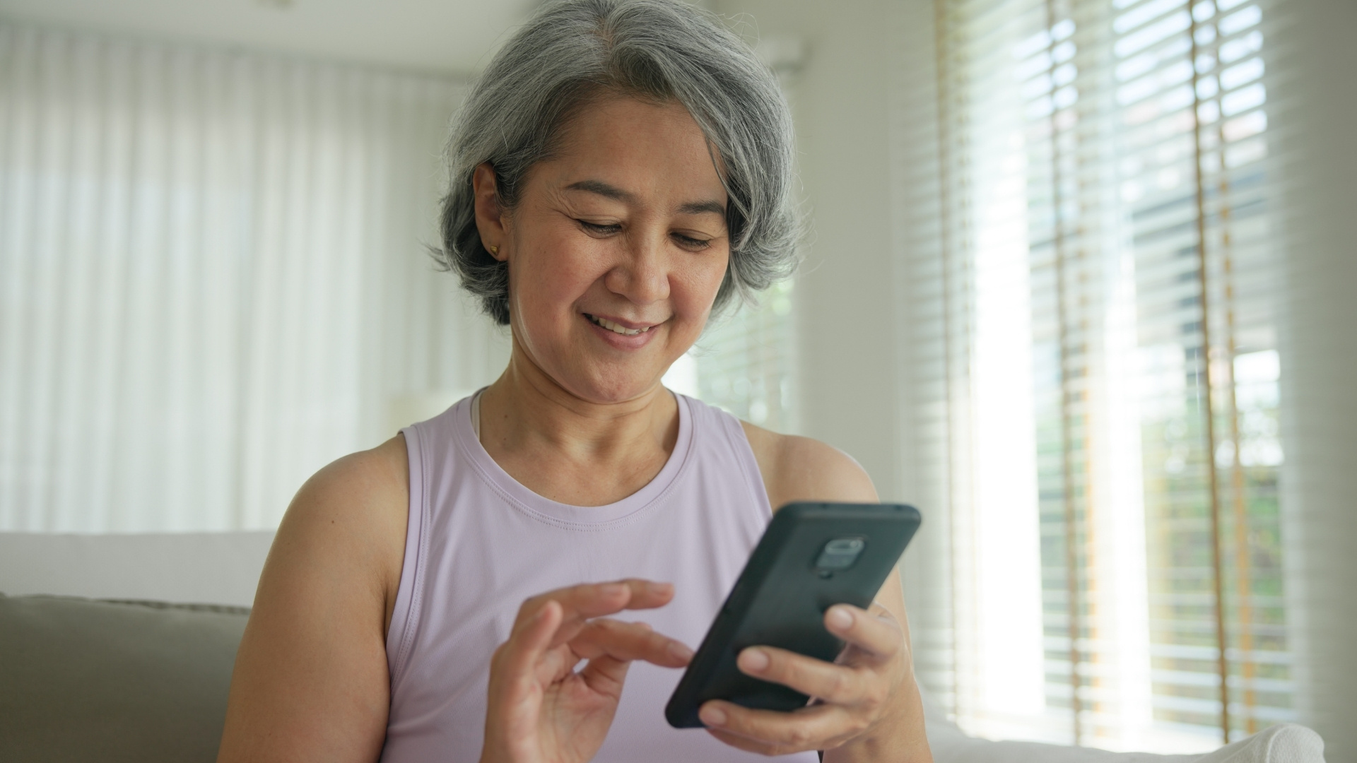 Woman ordering repeat prescription using The Doctors App
