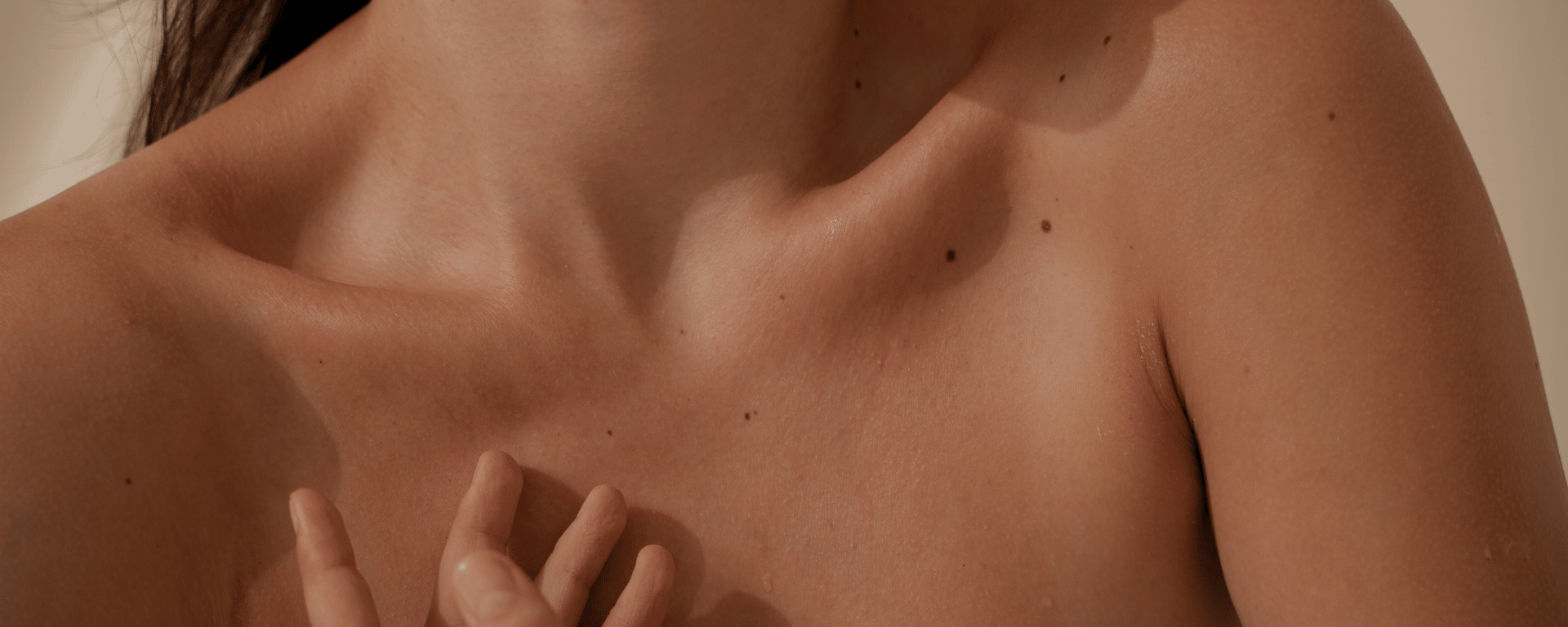 Woman showing skin with moles