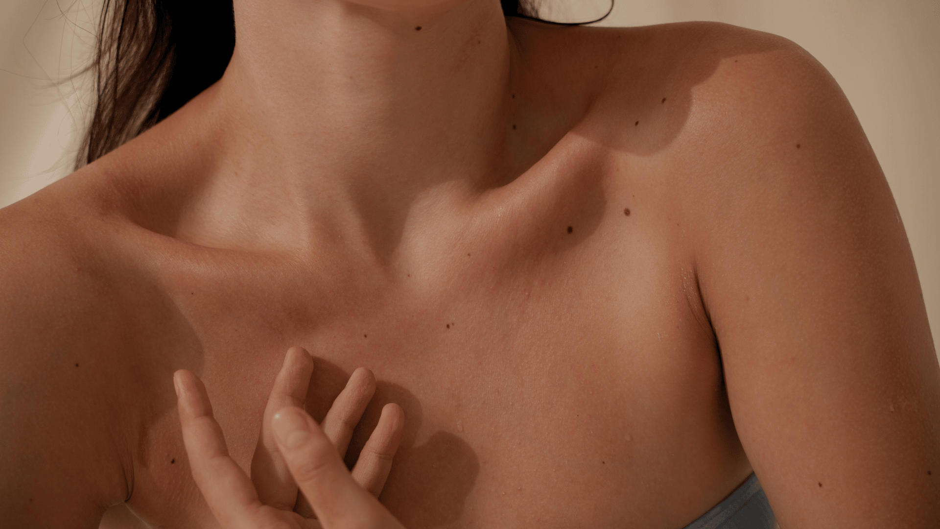 Woman showing skin with moles