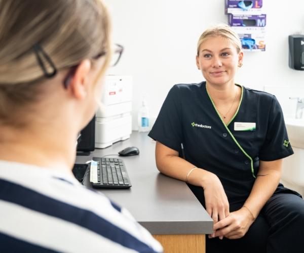 lady with friendly medical staff at the doctors