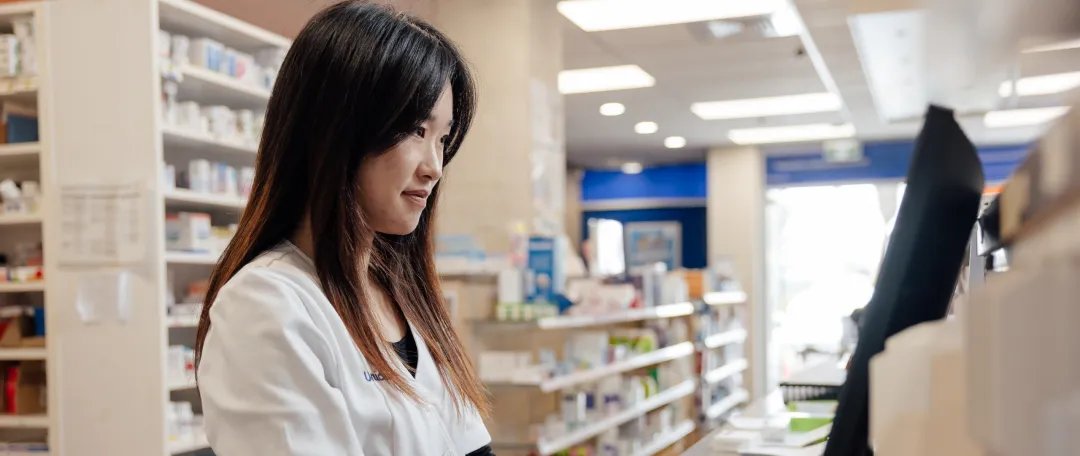 Pharmacist filling repeat prescription for a patient